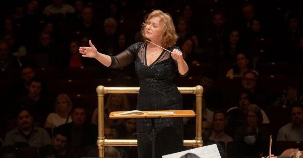 A woman conducting at Carnegie Hall.